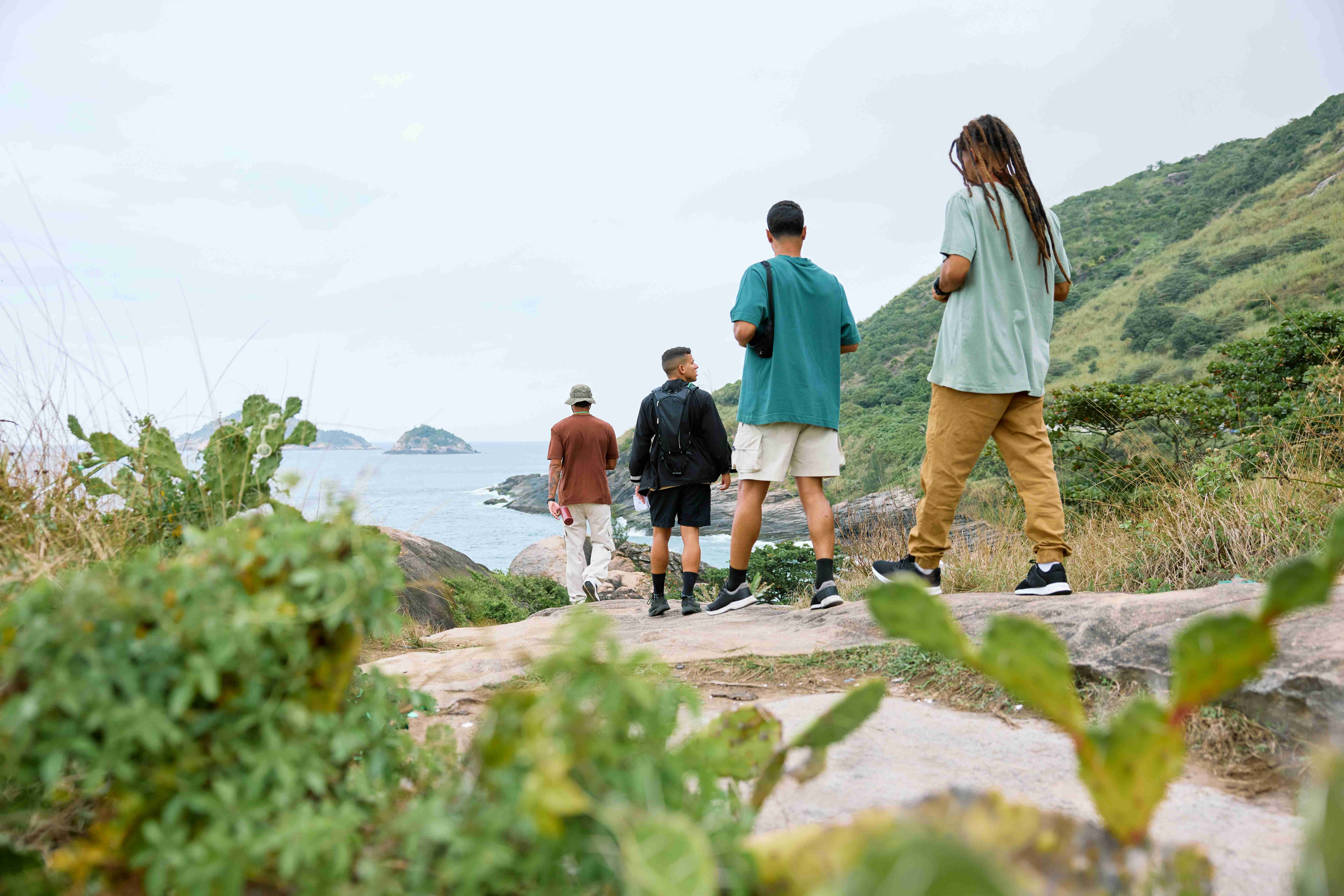 a group of people standing on top of a hill