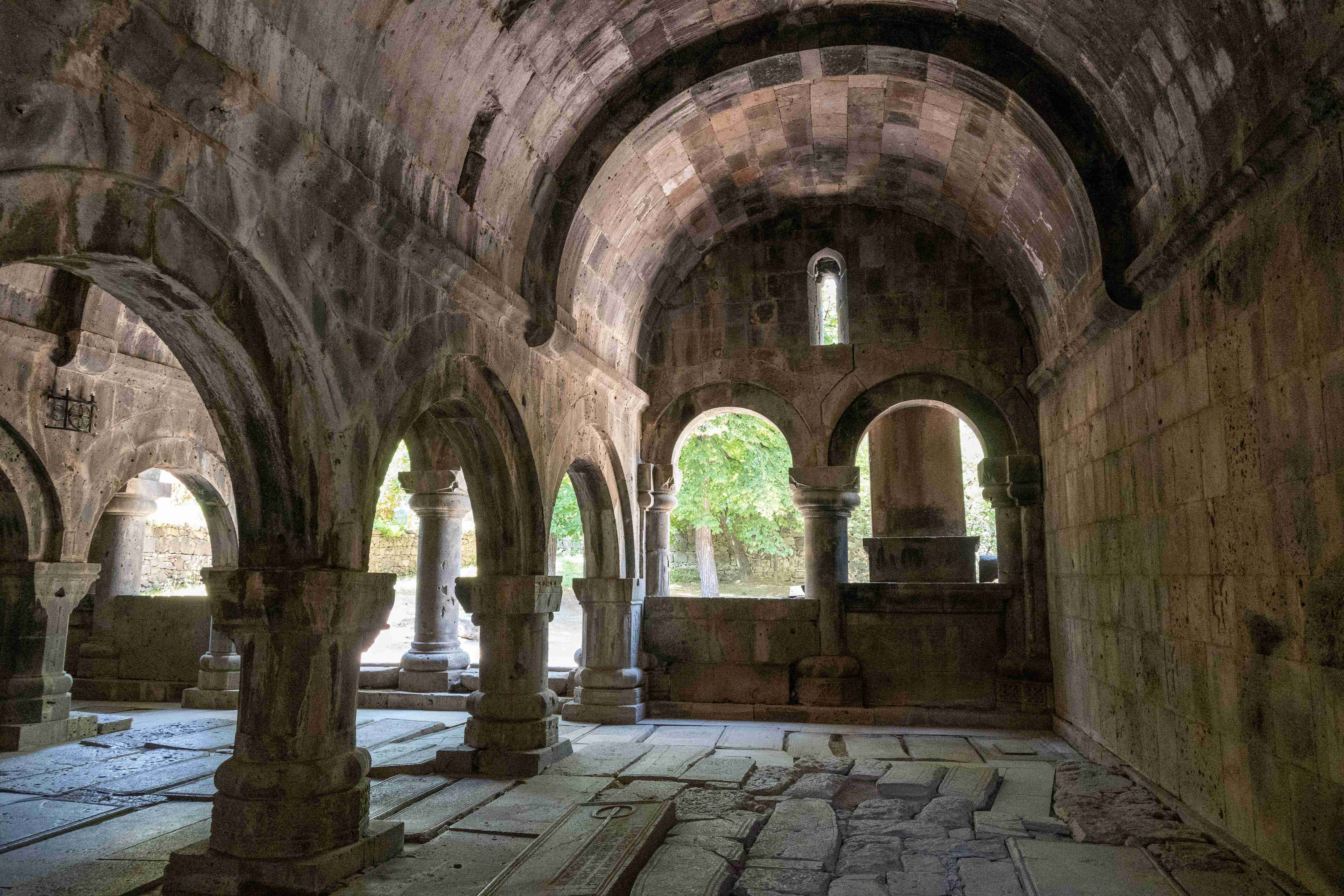 a-stone-walkway-with-arches-and-columns