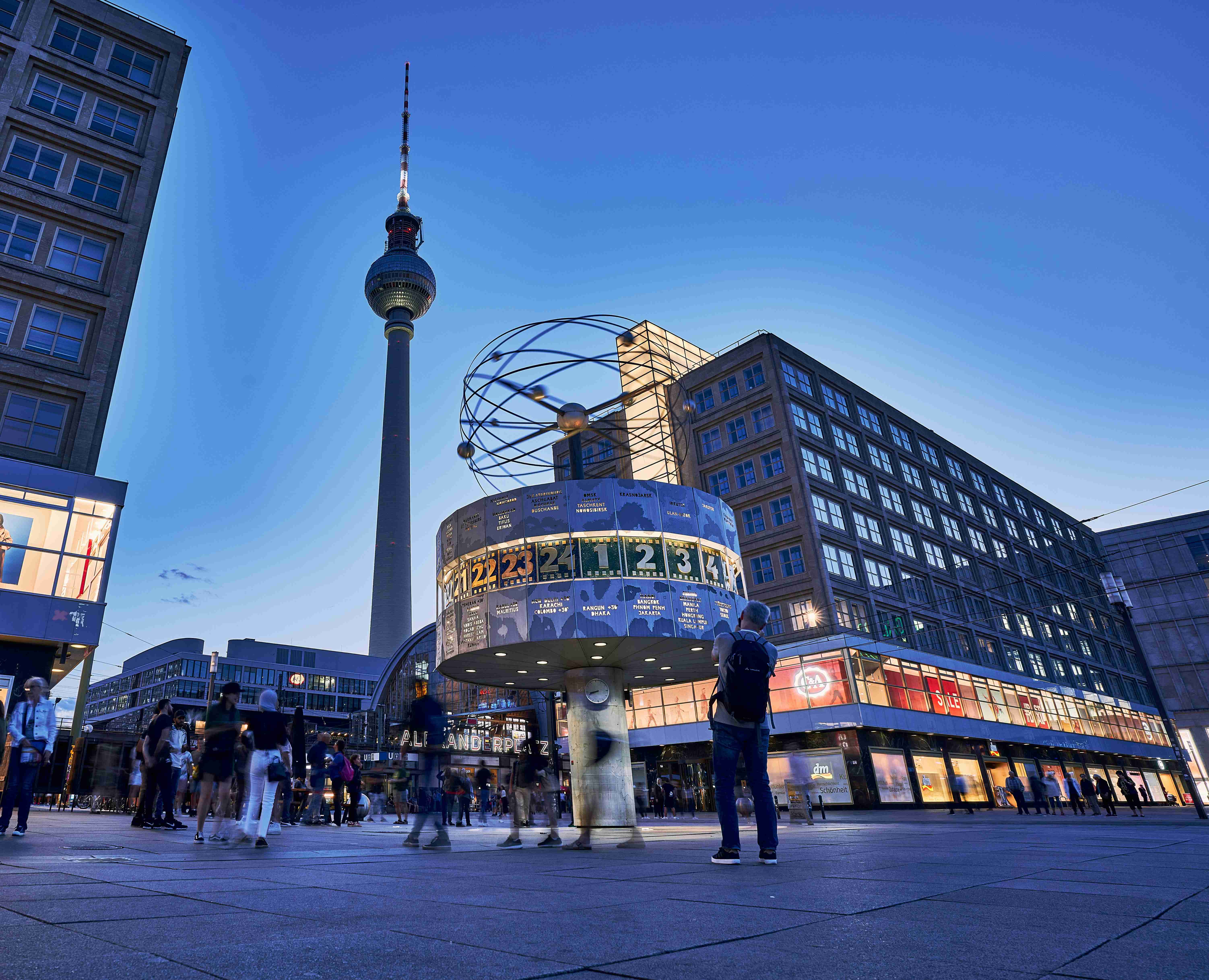 a-group-of-people-standing-in-front-of-a-tall-building