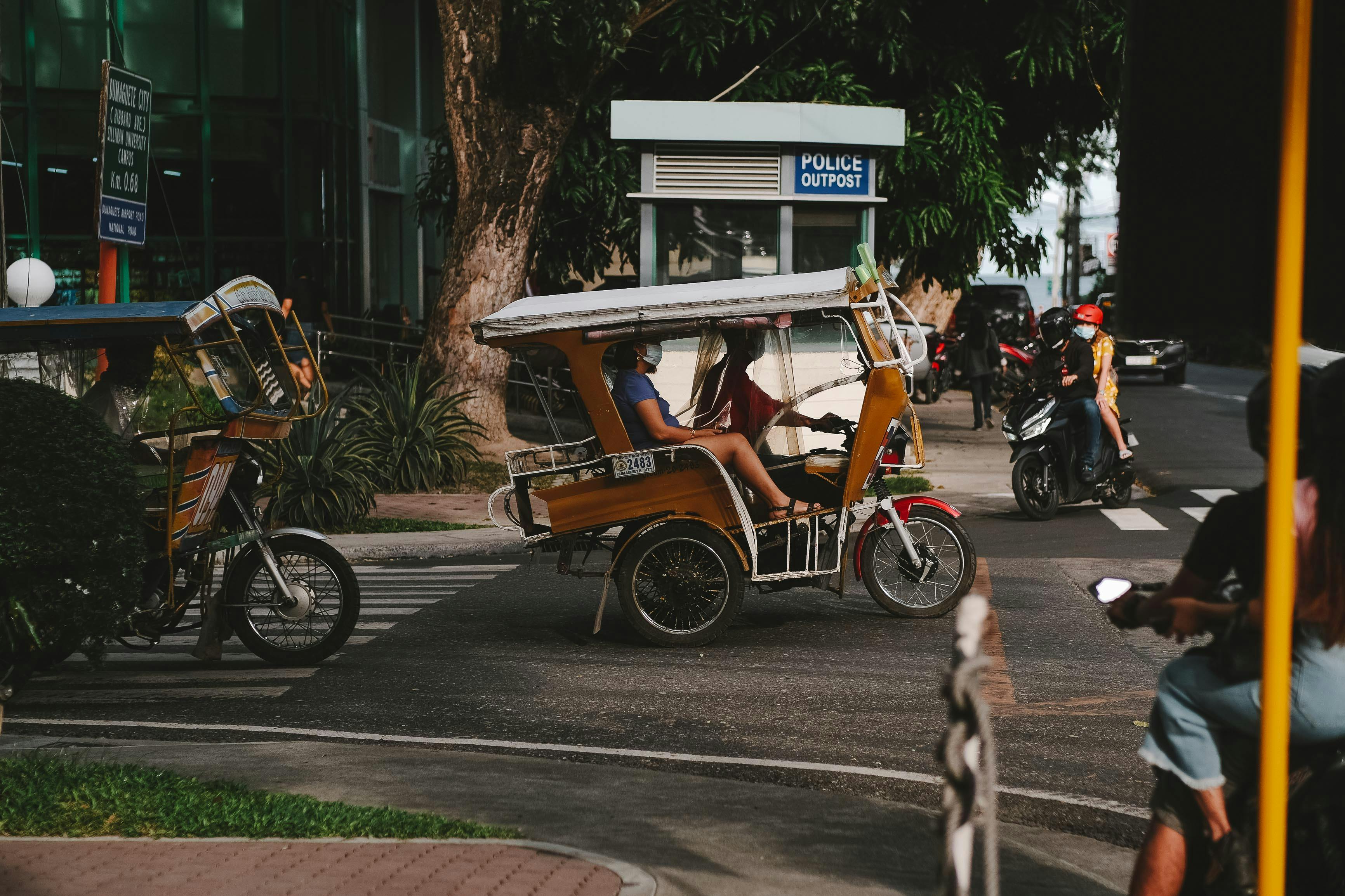 a person riding brown tricycle