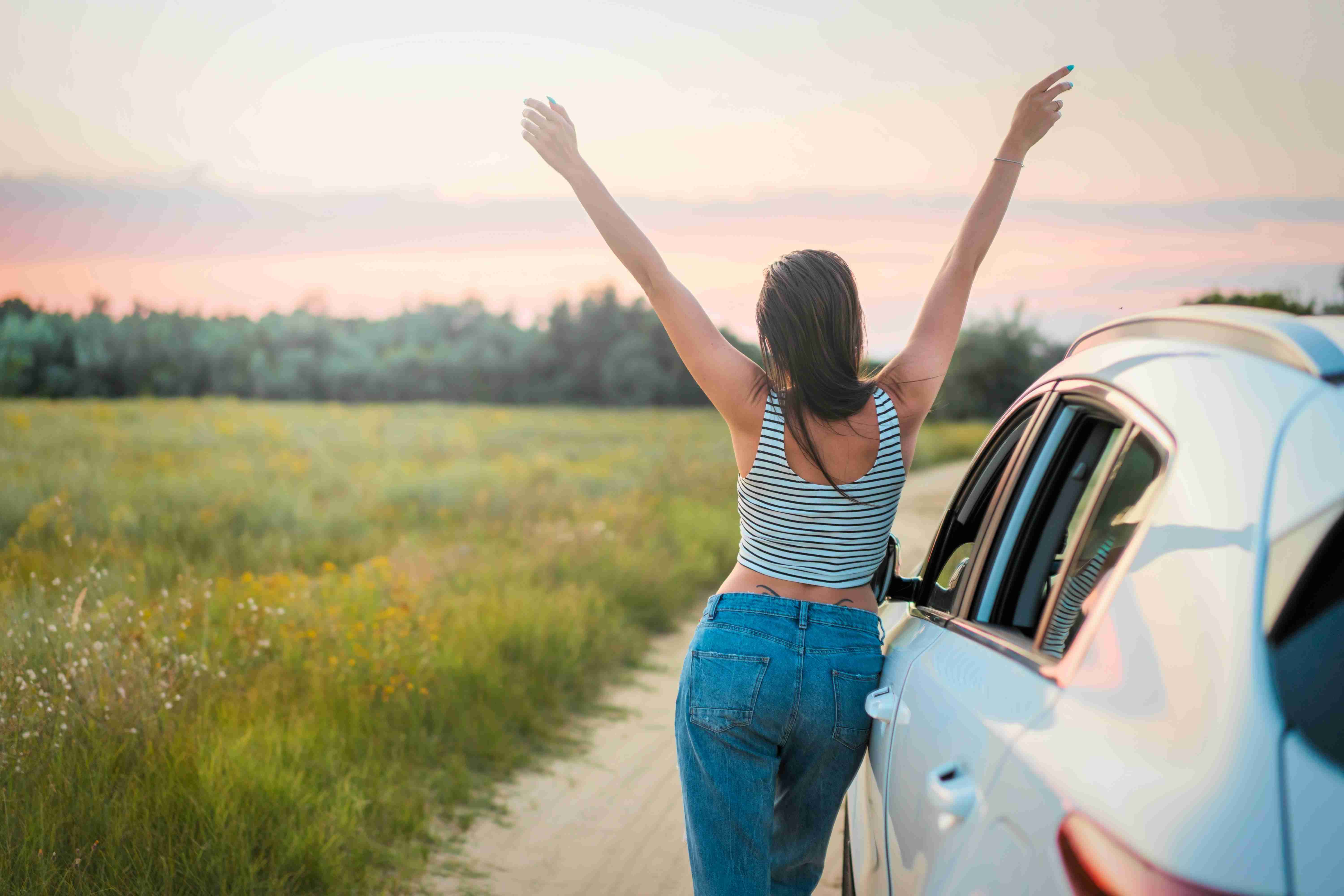 woman-leaning-beside-vehicle