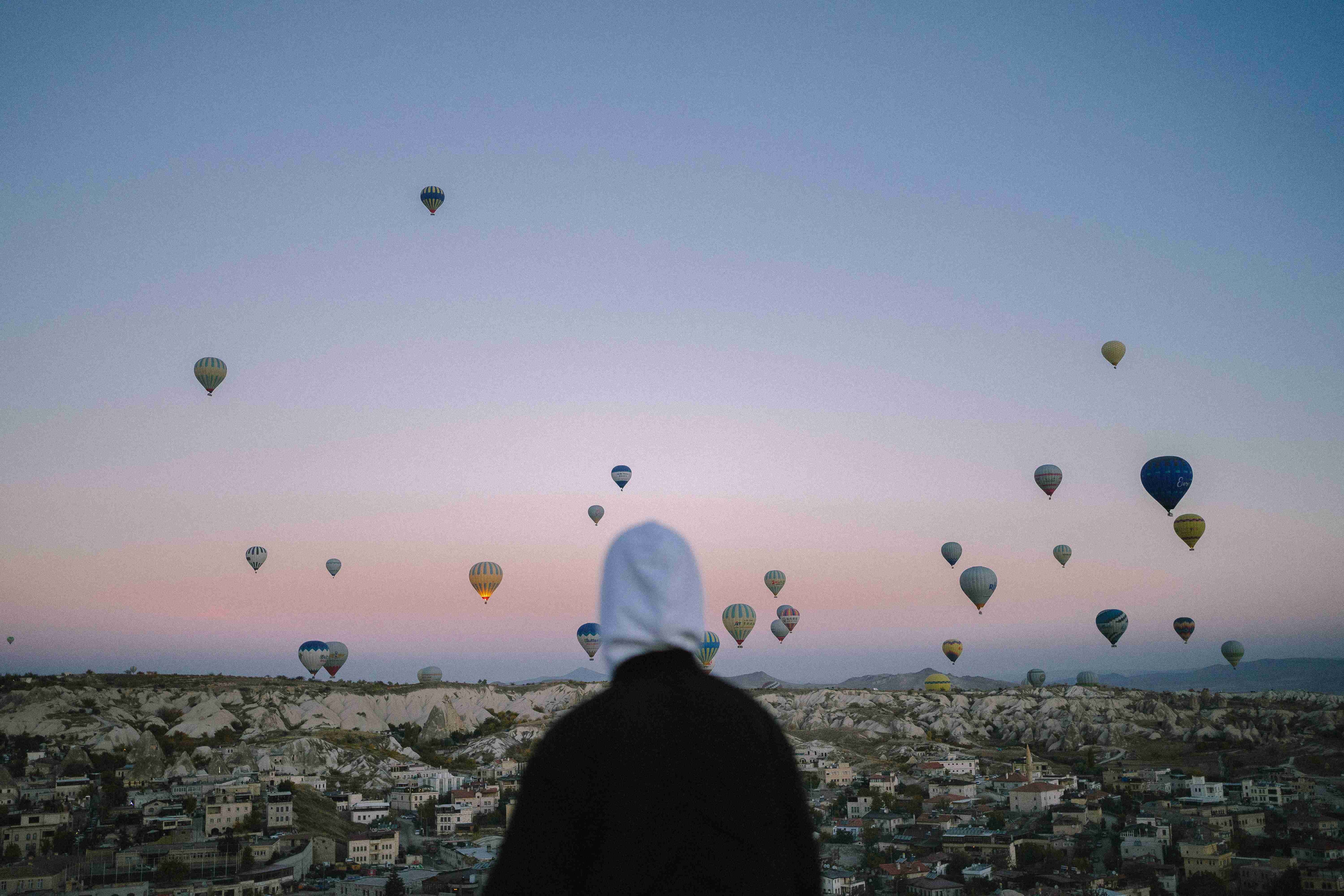 Person Watching Hot Air Balloons Flying Over Cappadocia