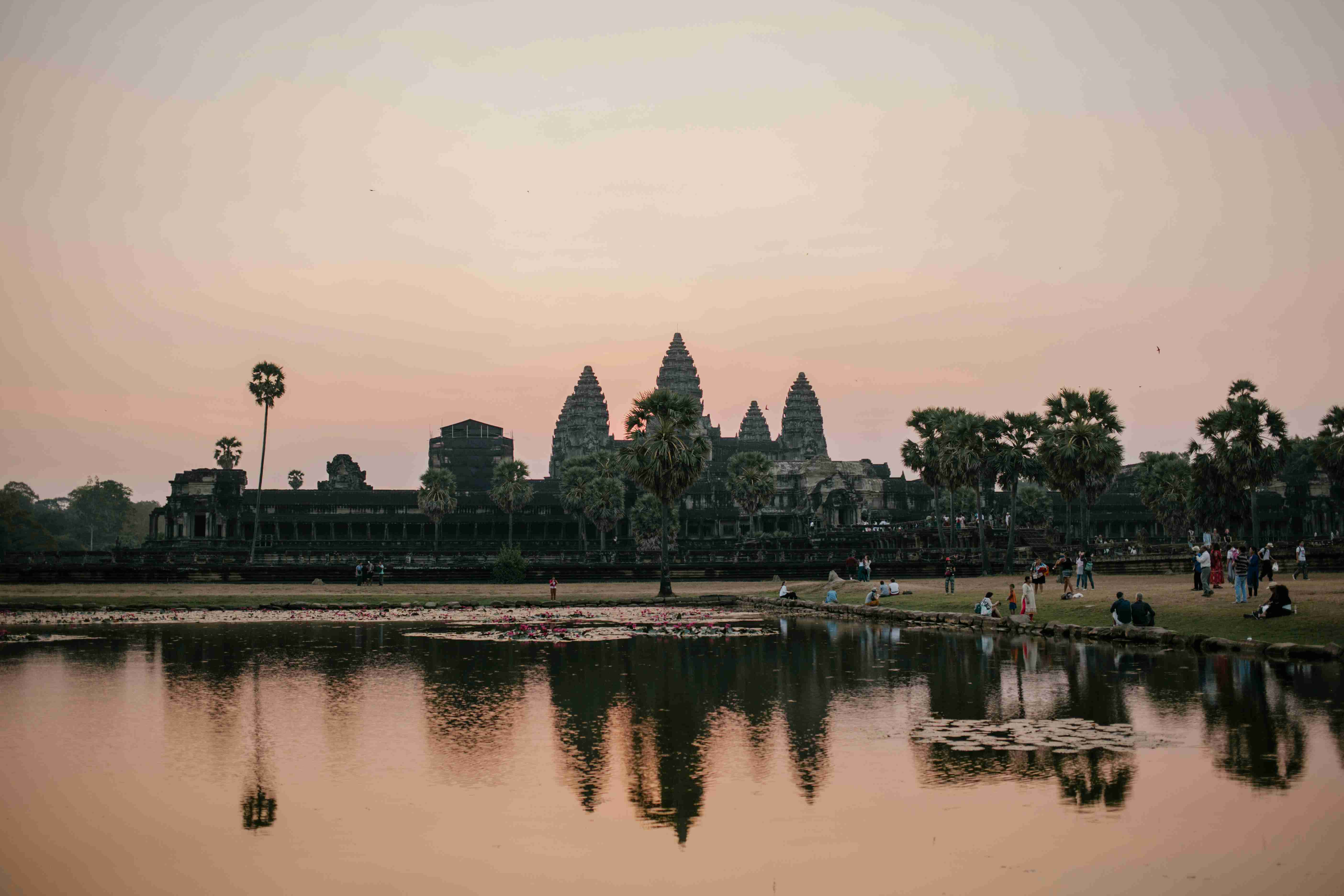 people by lake near angkor wat in cambodia
