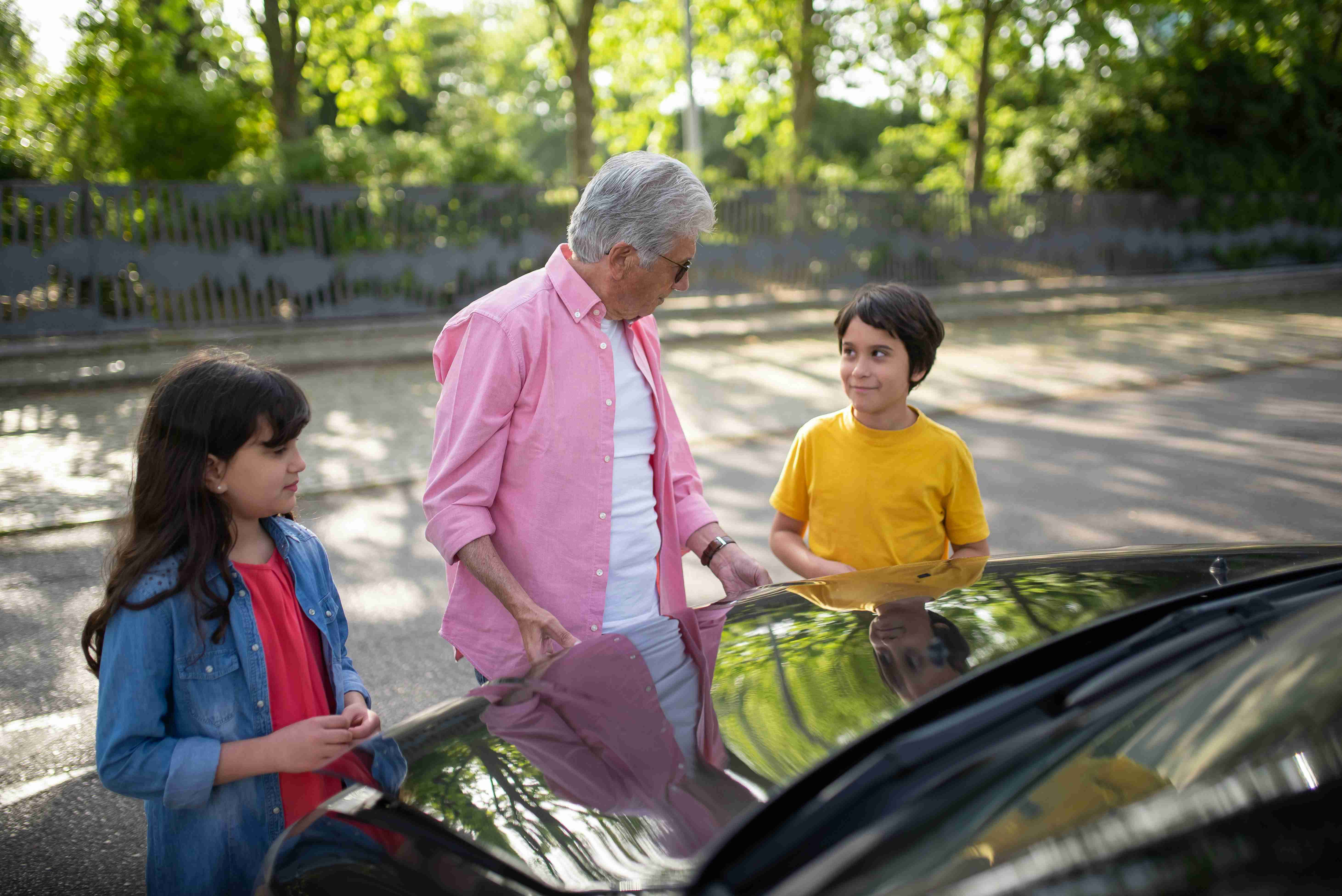 a man opening the hood of a car