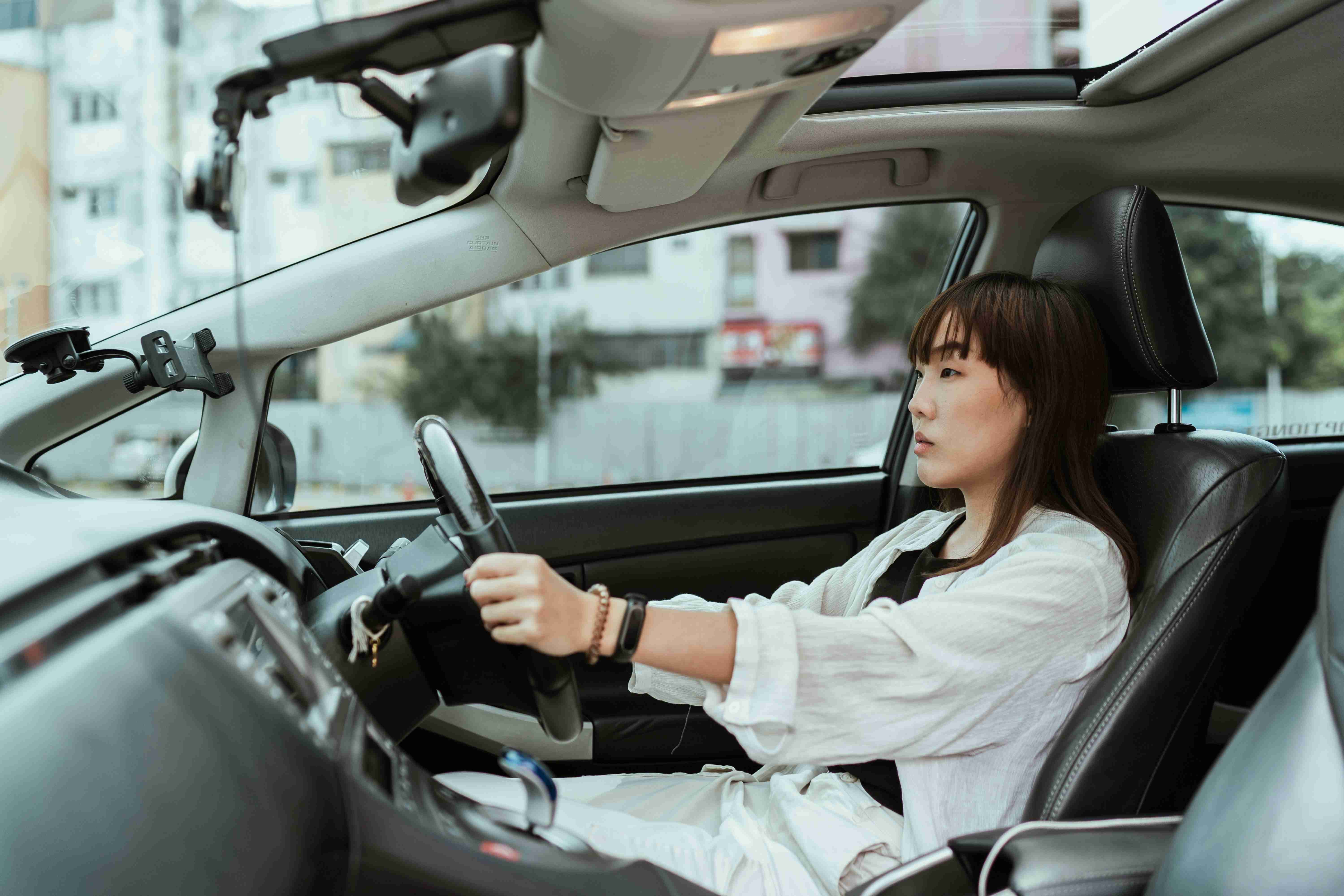 serious-asian-woman-driving-right-hand-car