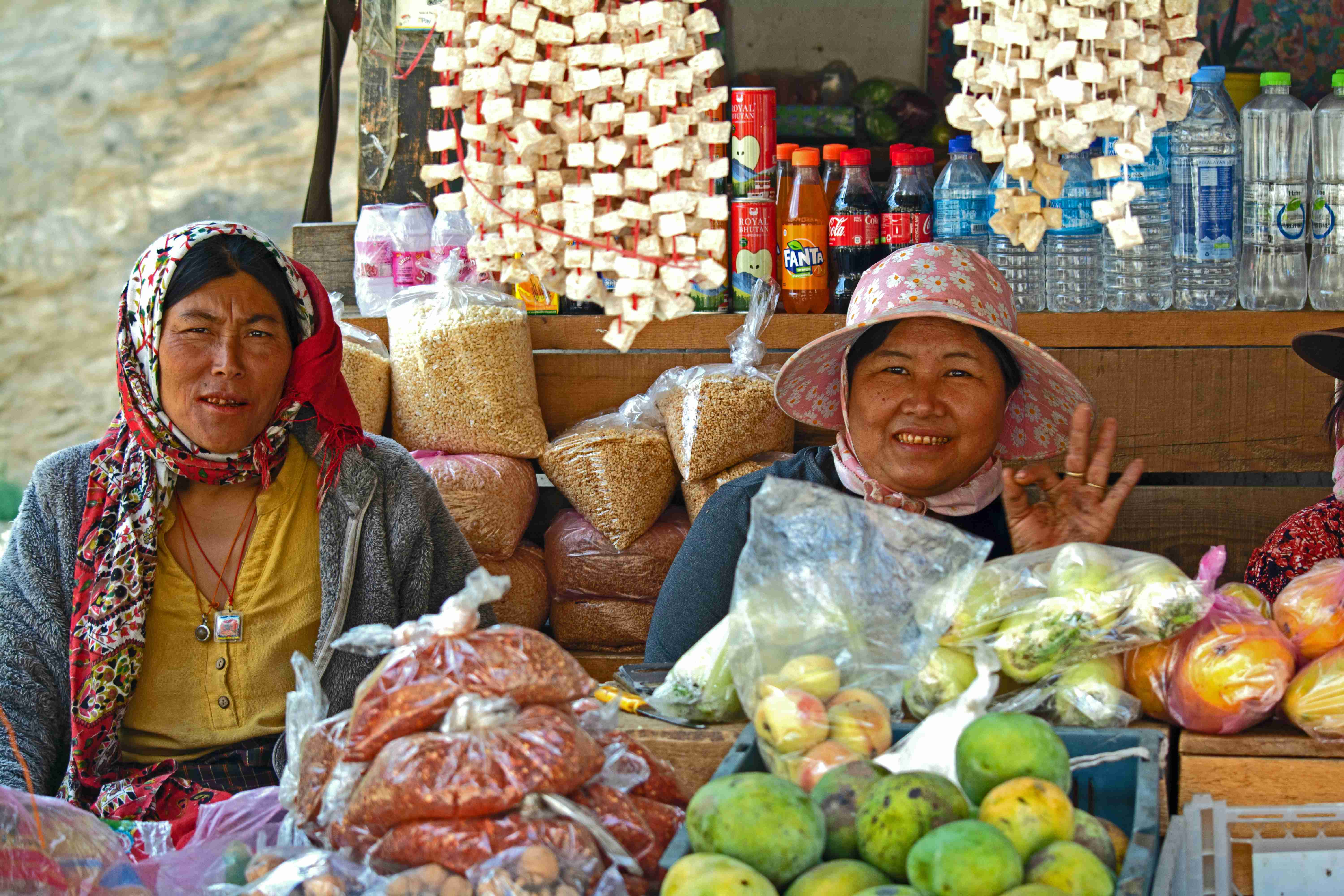 smiling woman vendors on stall