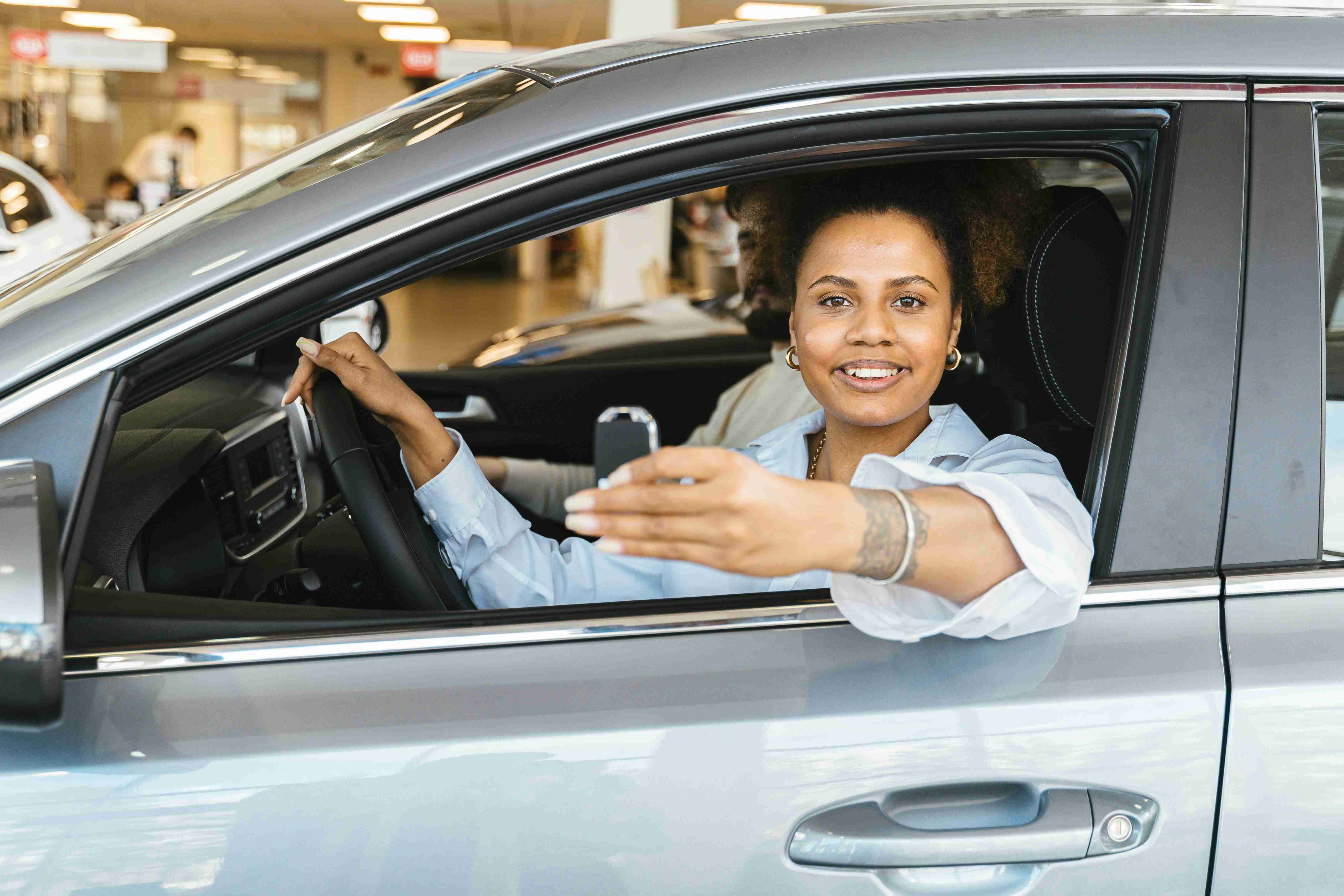 photo of a woman holding a car key