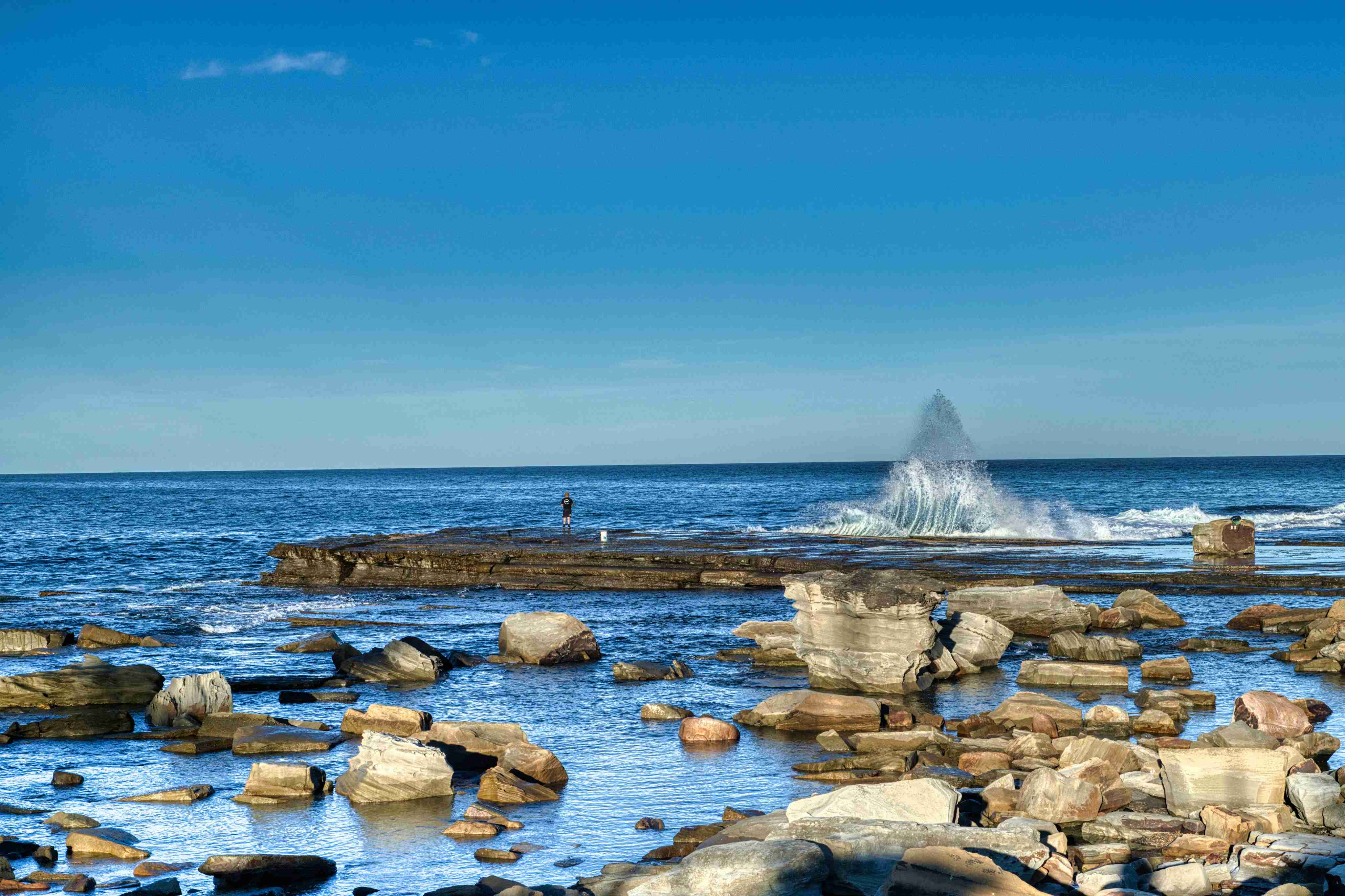 a-large-body-of-water-surrounded-by-rocks