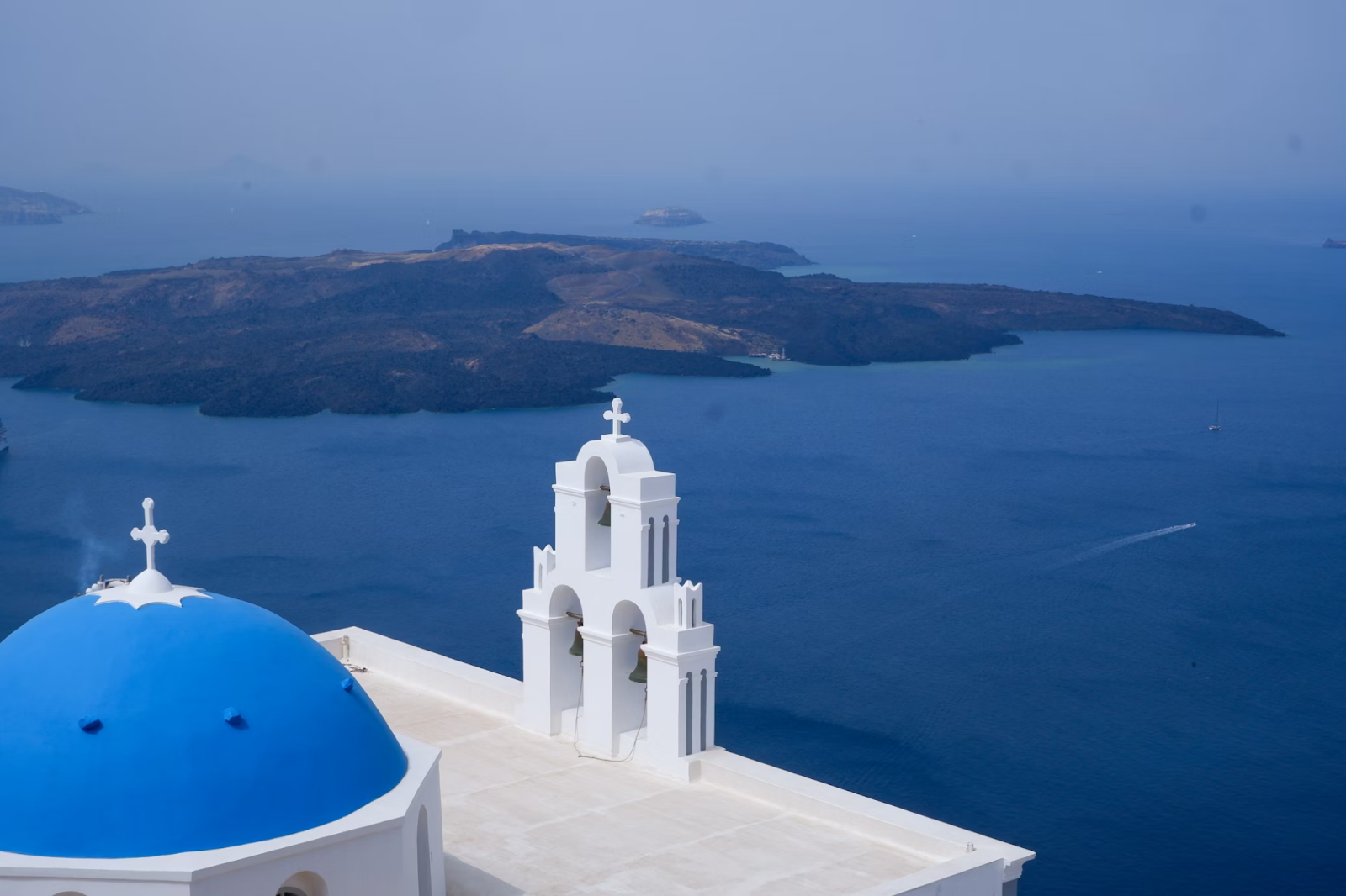 Santorini's Iconic Blue Domed Church Overlooking the Sea