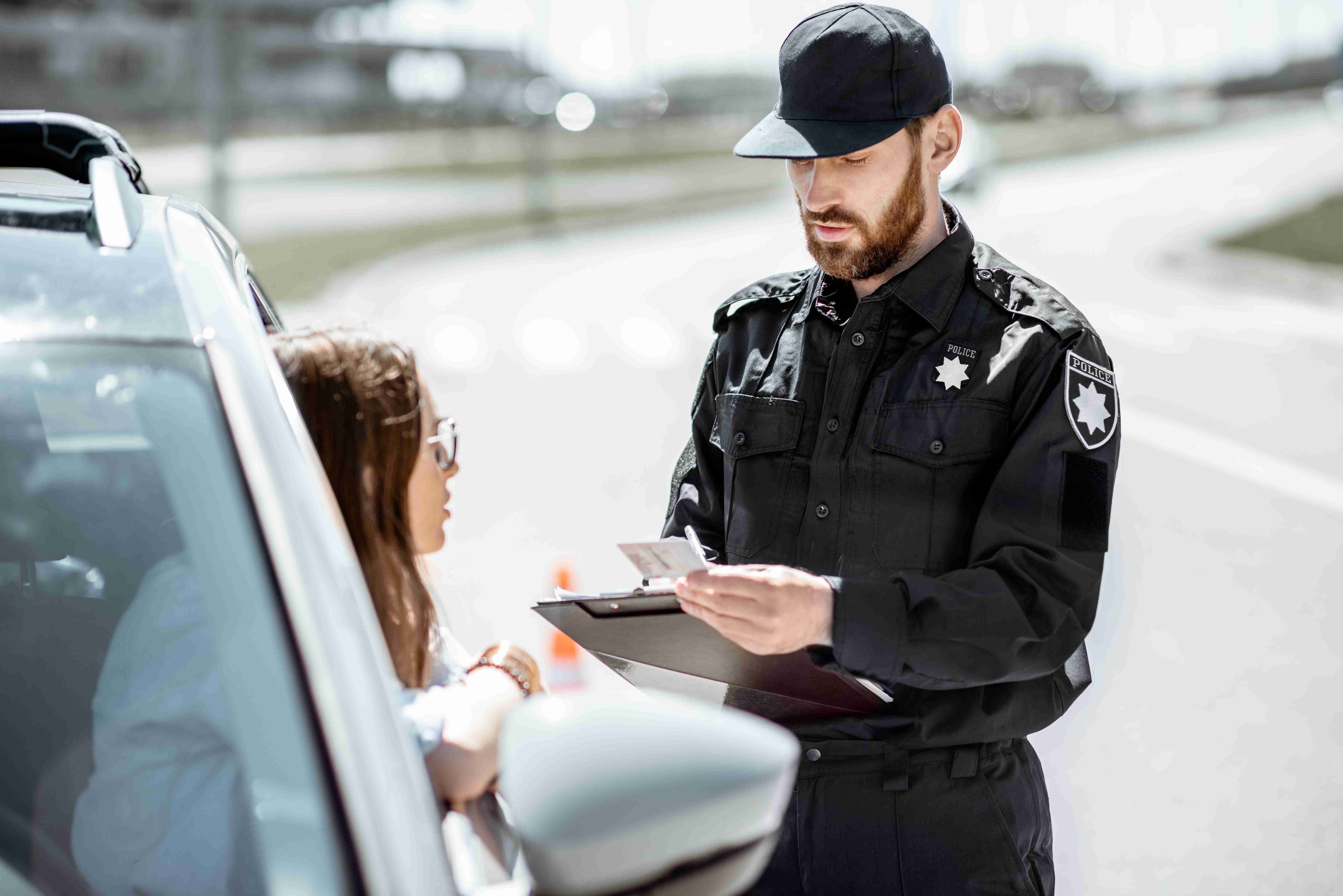 policeman with woman driver on the road