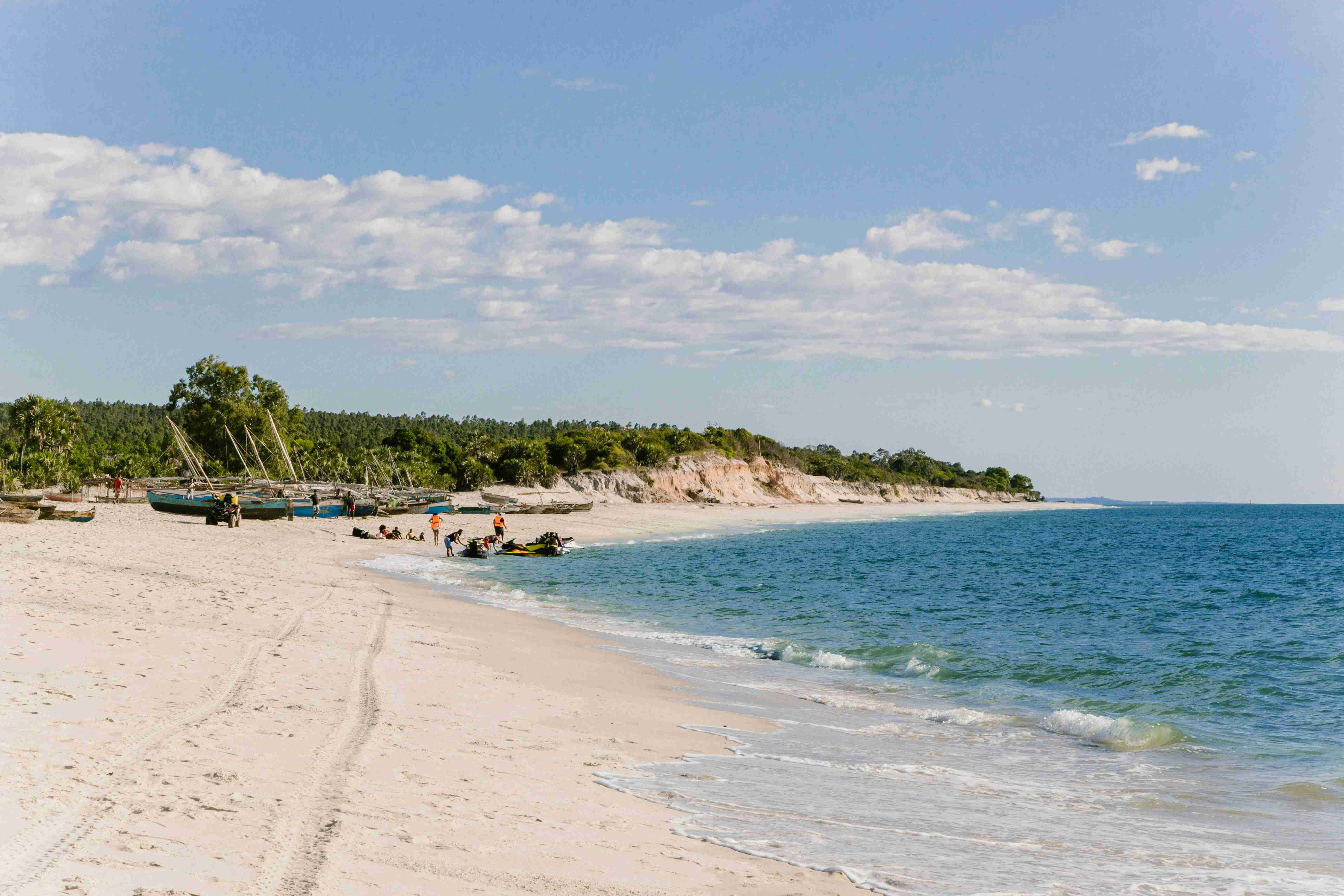 egy csoport ember a tengerparton, egy víztest közelében