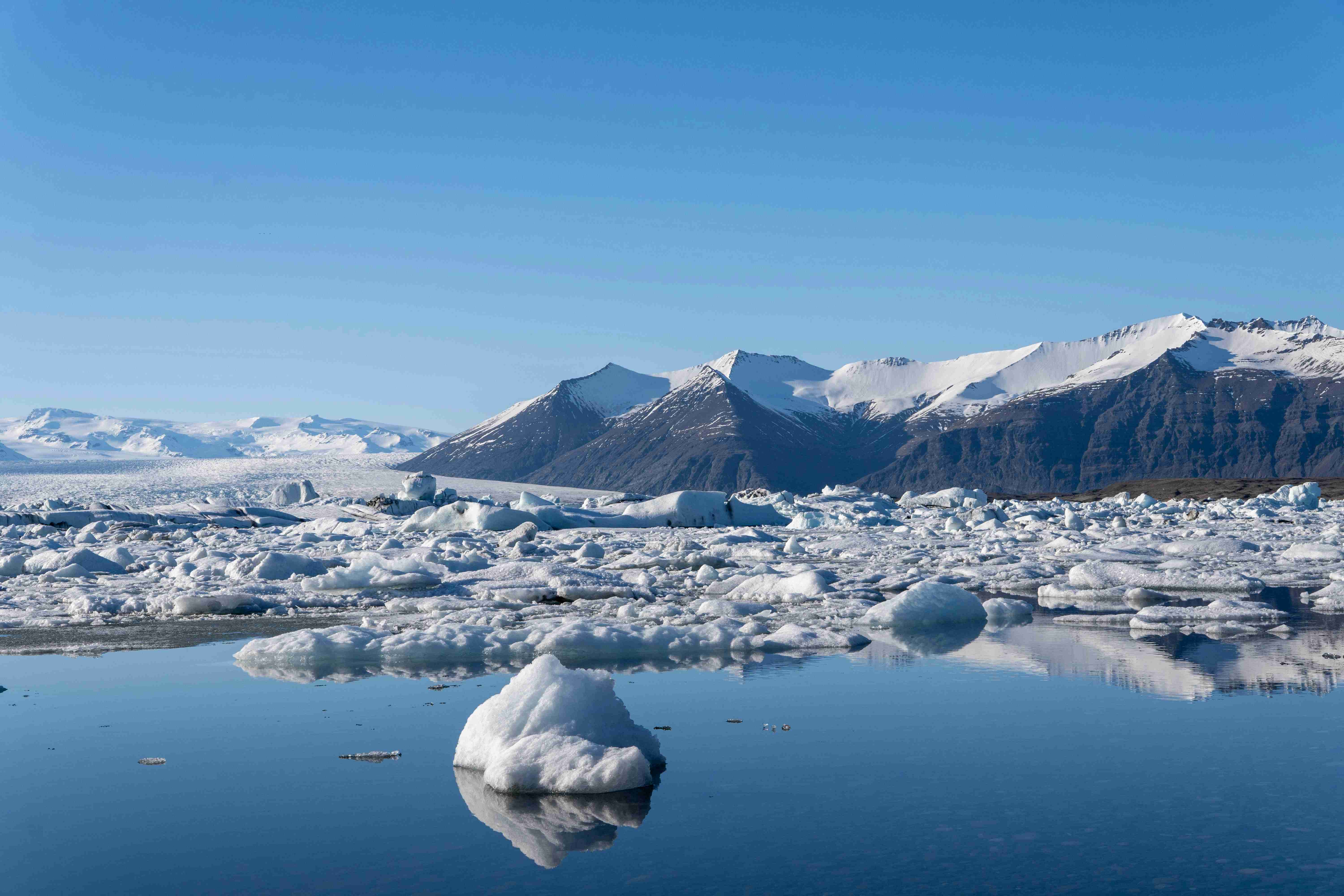 a large body of water surrounded by snow