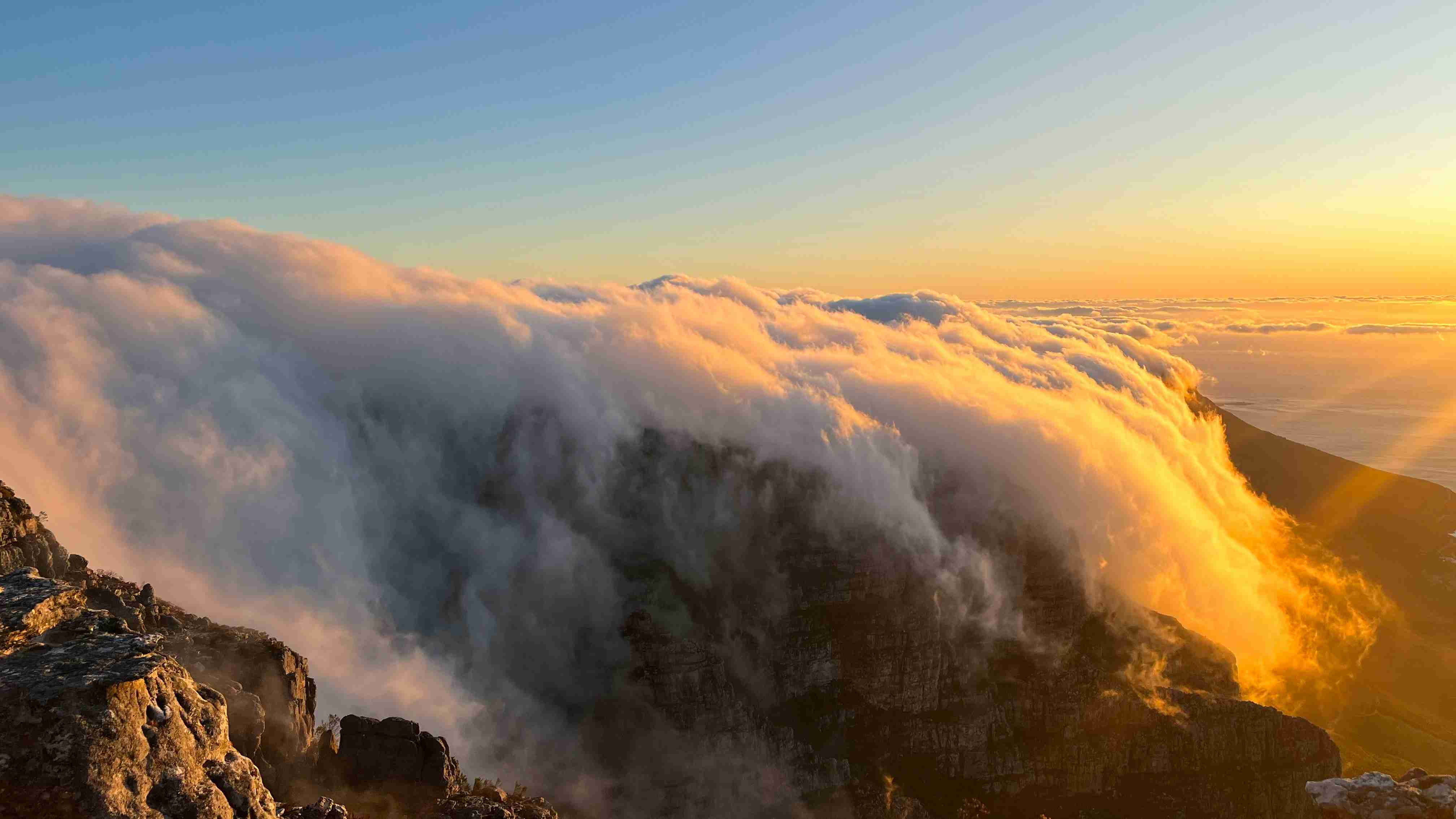 the sun is shining through the clouds