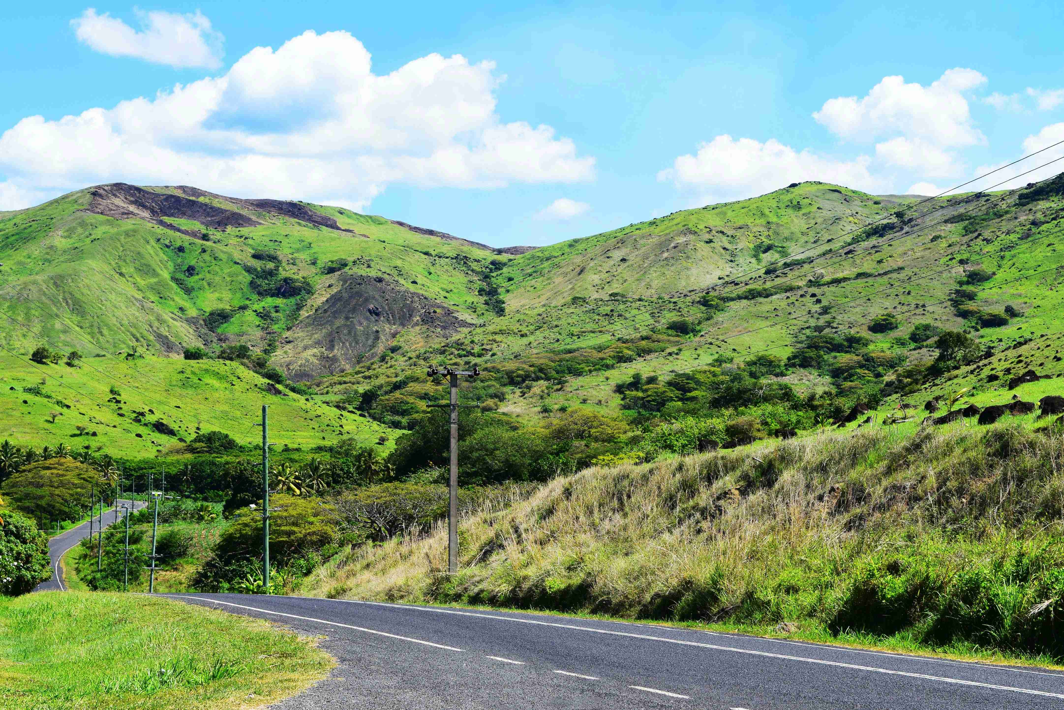a road with a mountain in the background