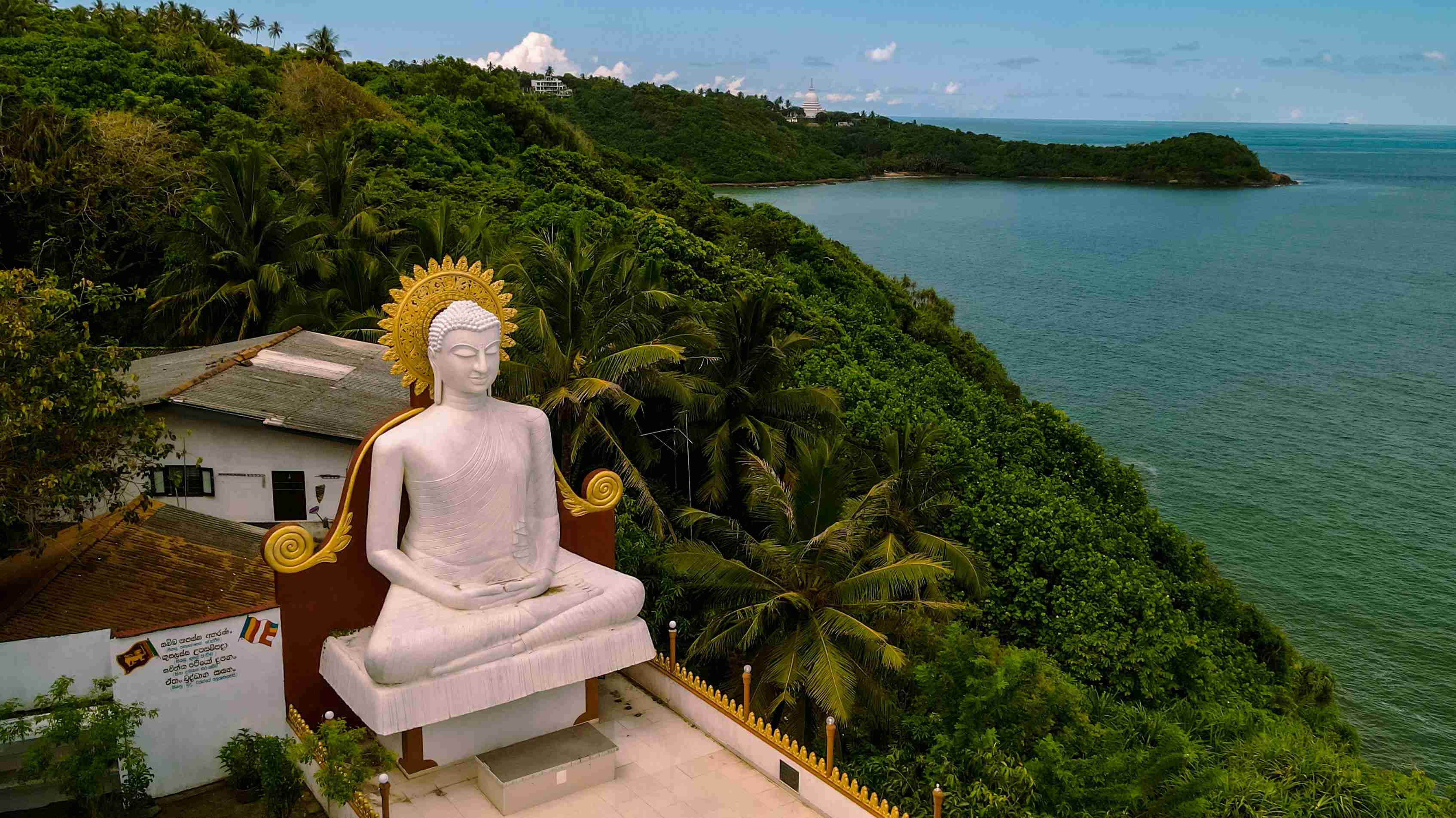 Serene Buddha Statue Overlooking Coastal Landscape