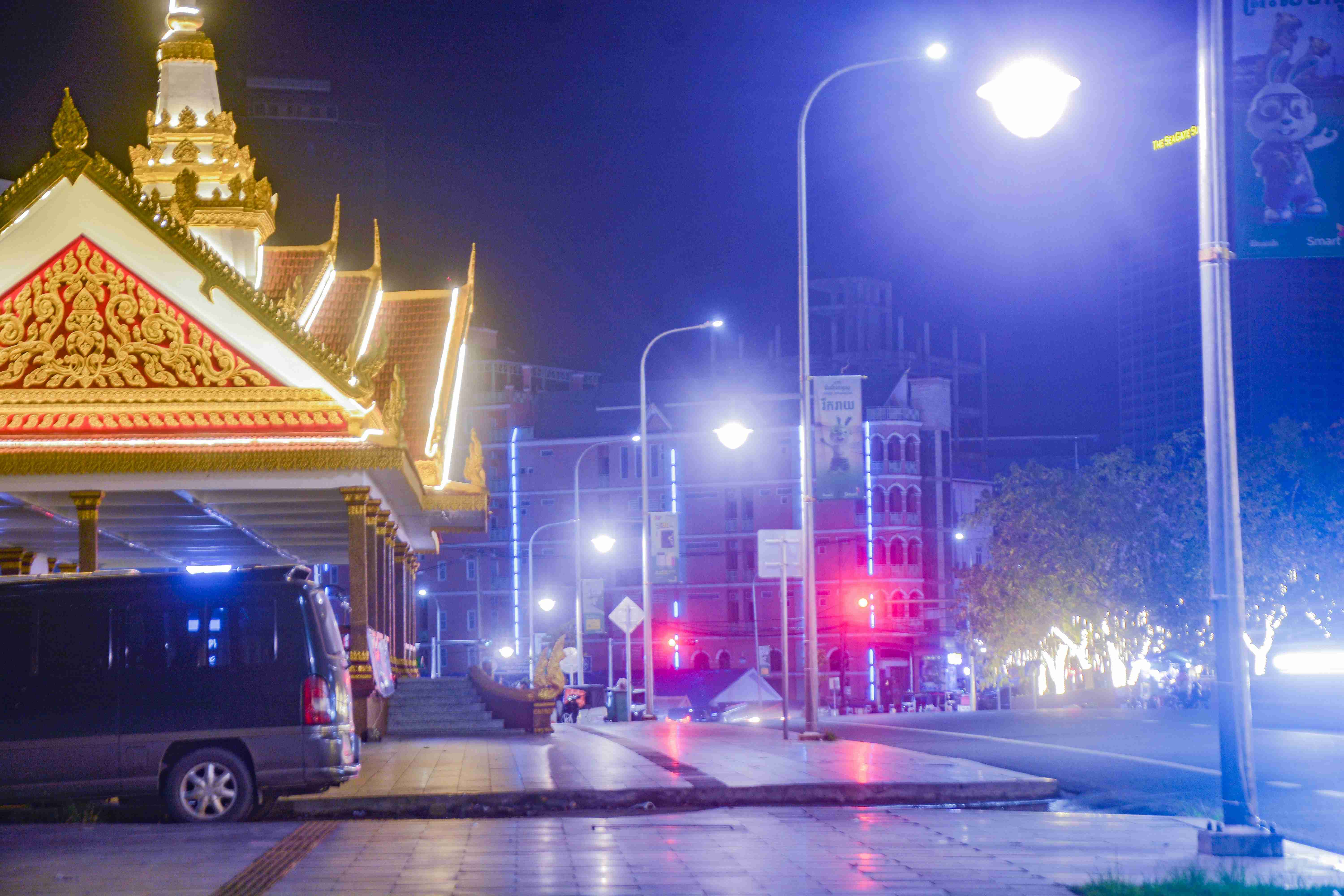 a-van-parked-in-front-of-a-building-at-night