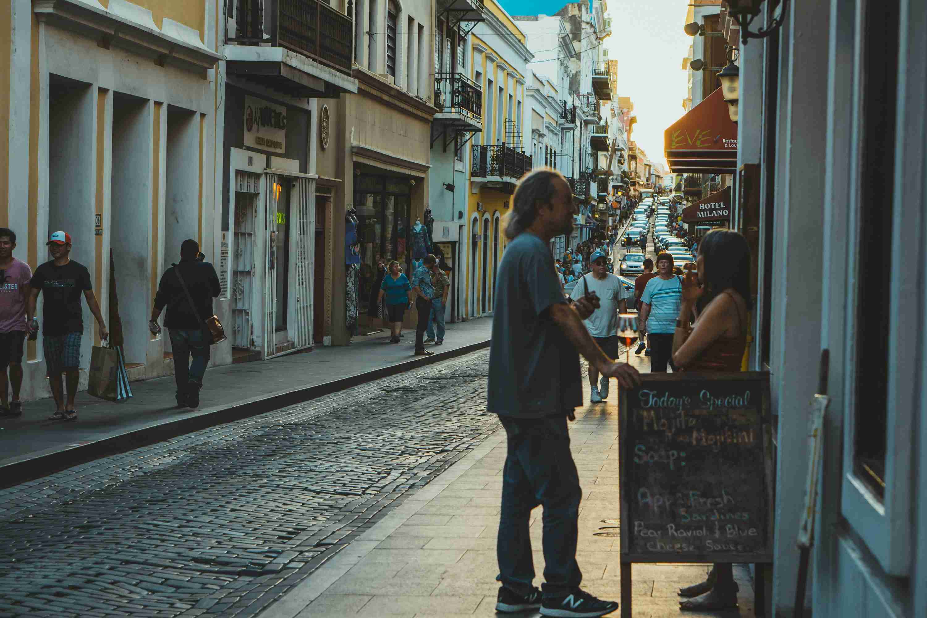 man leaning on signboard