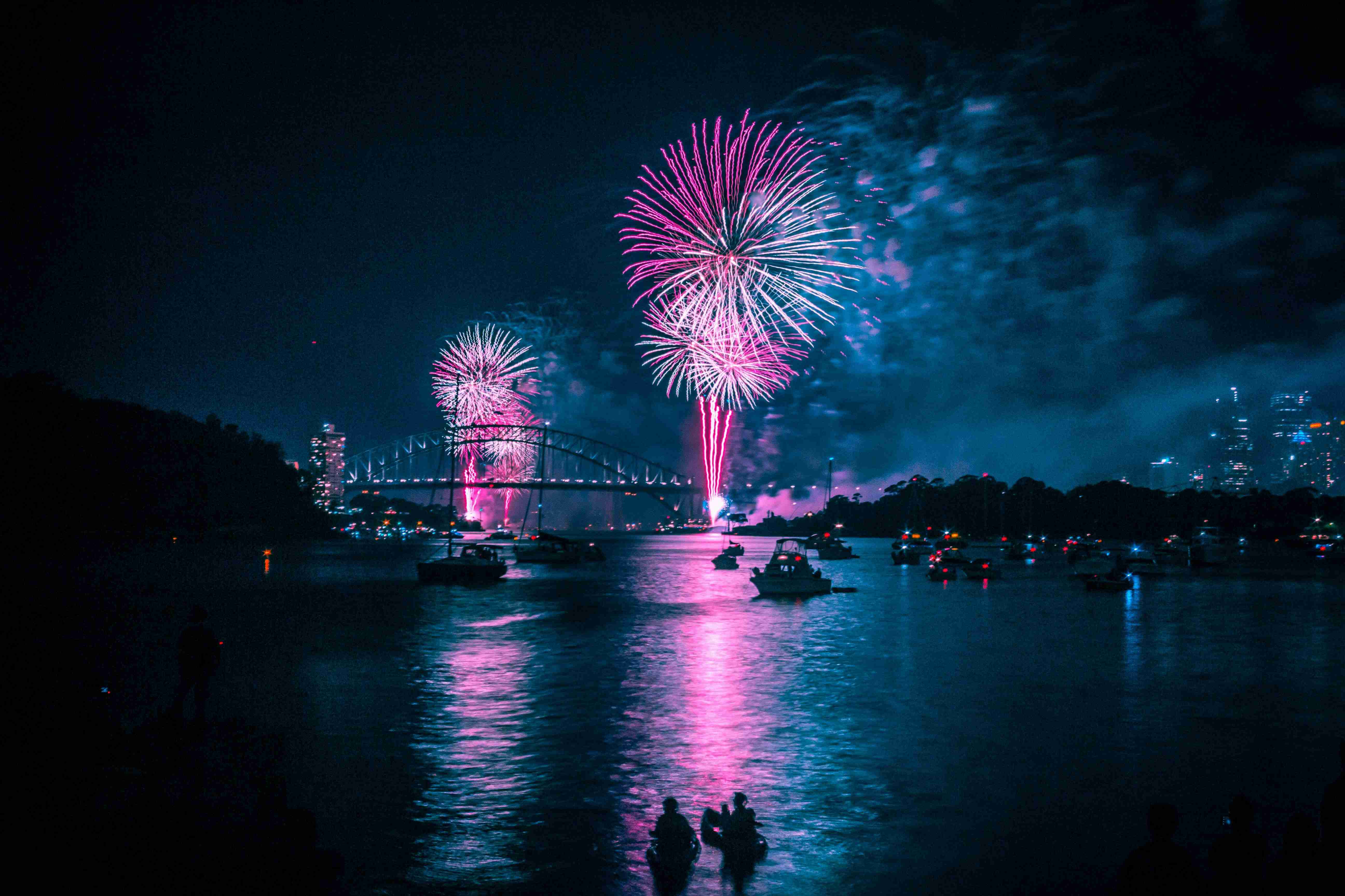 fireworks above long bridge at night time