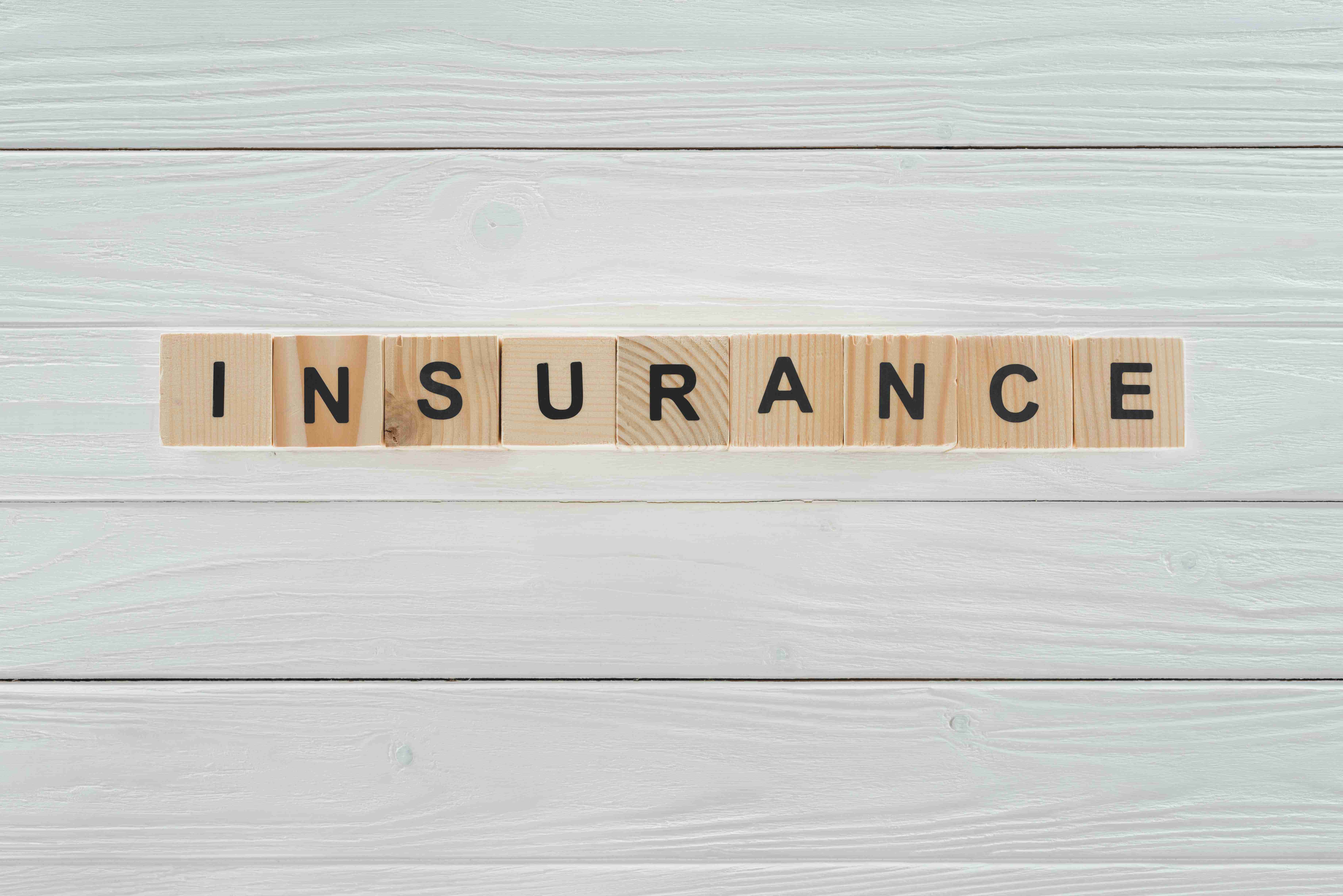 top view of insurance word made of wooden blocks