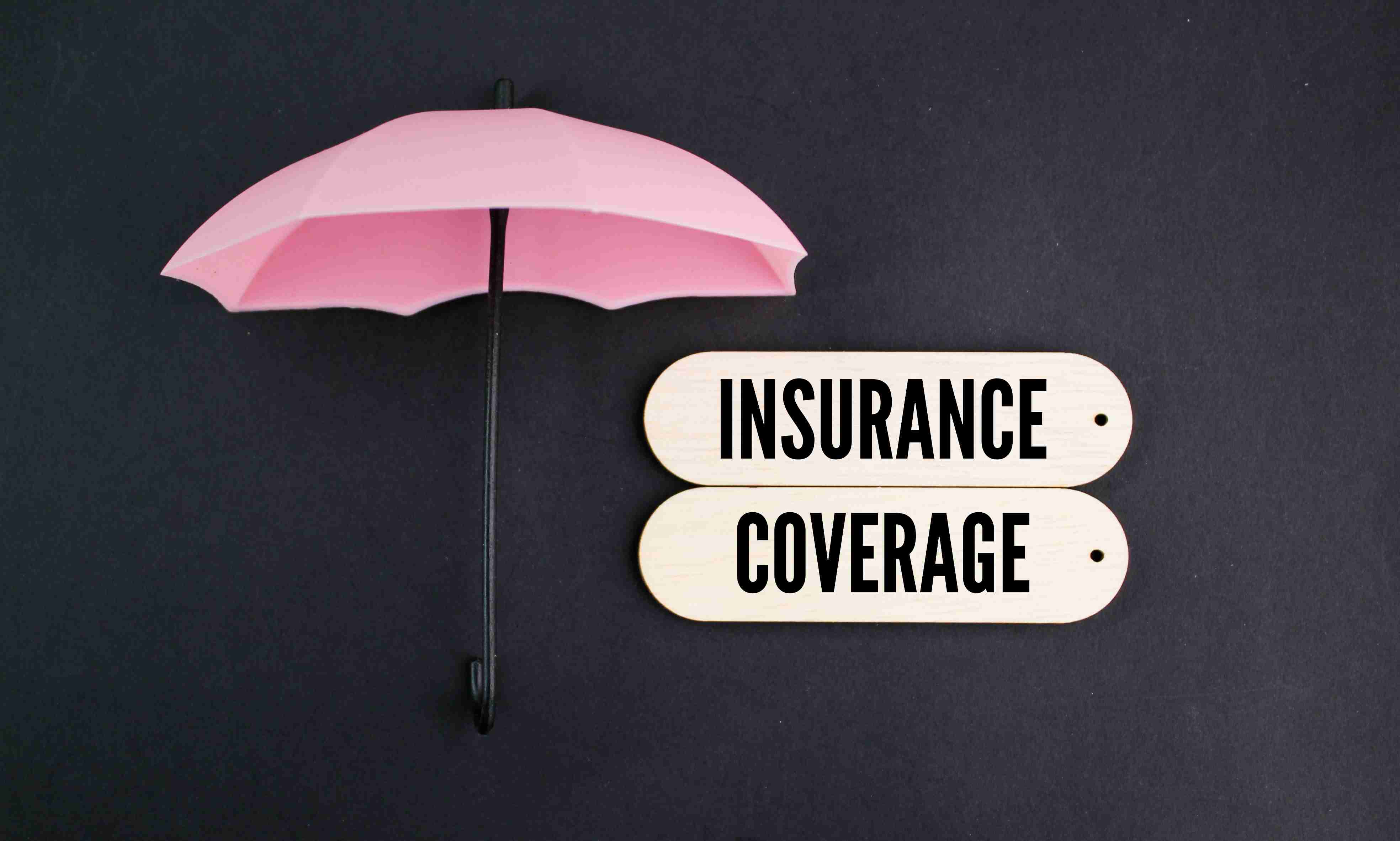 umbrella and board with the word Insurance coverage