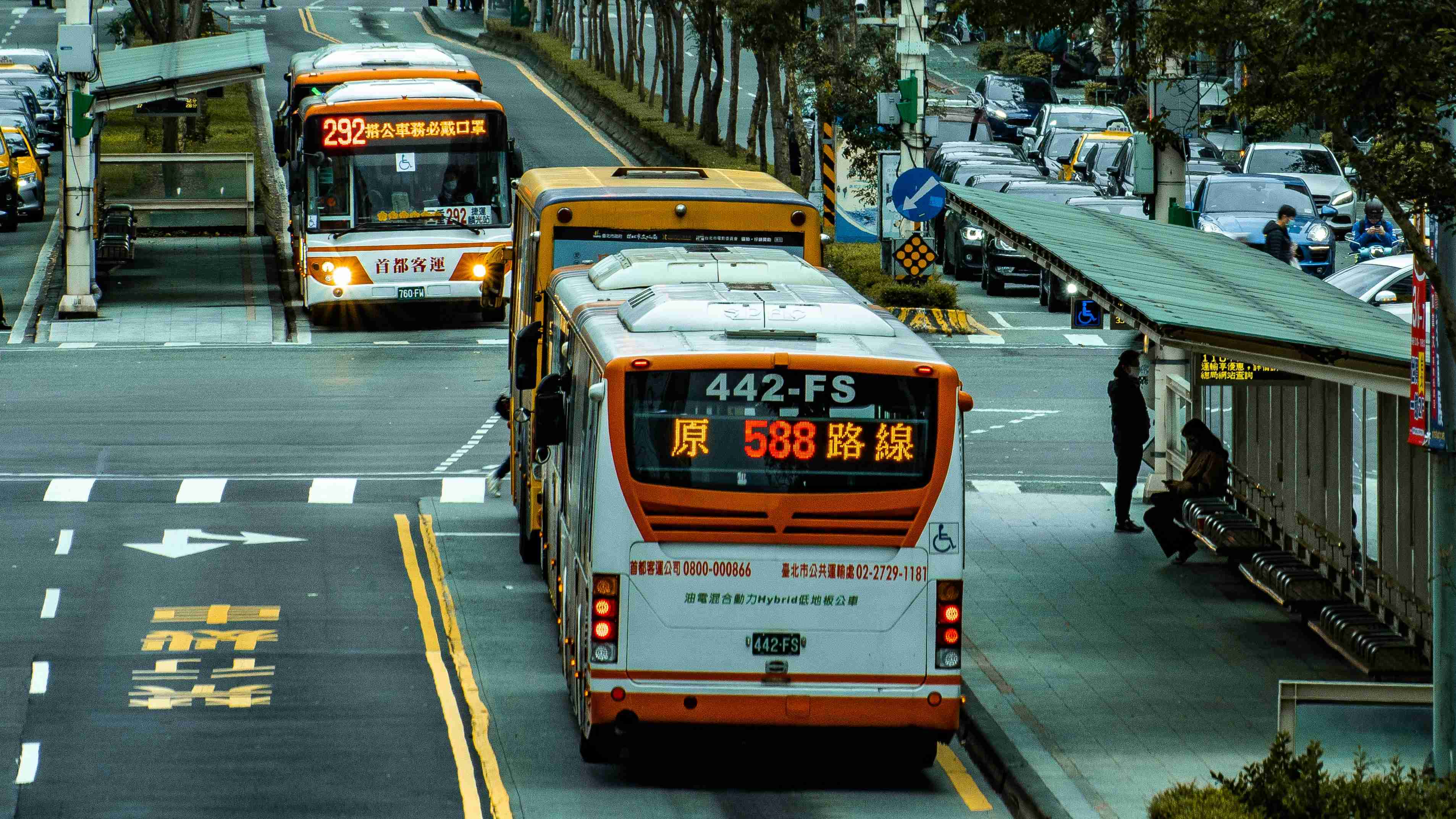 white-and-red-bus-on-road-during-daytime